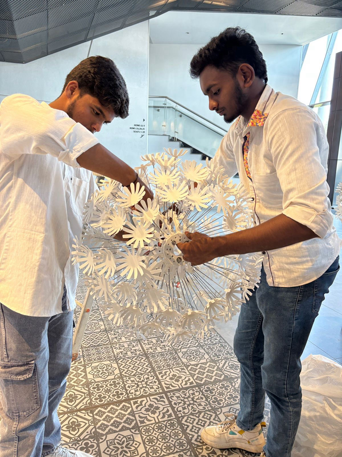 team I students assembling a paper flower installation at InvokED 4.0 Bangalore