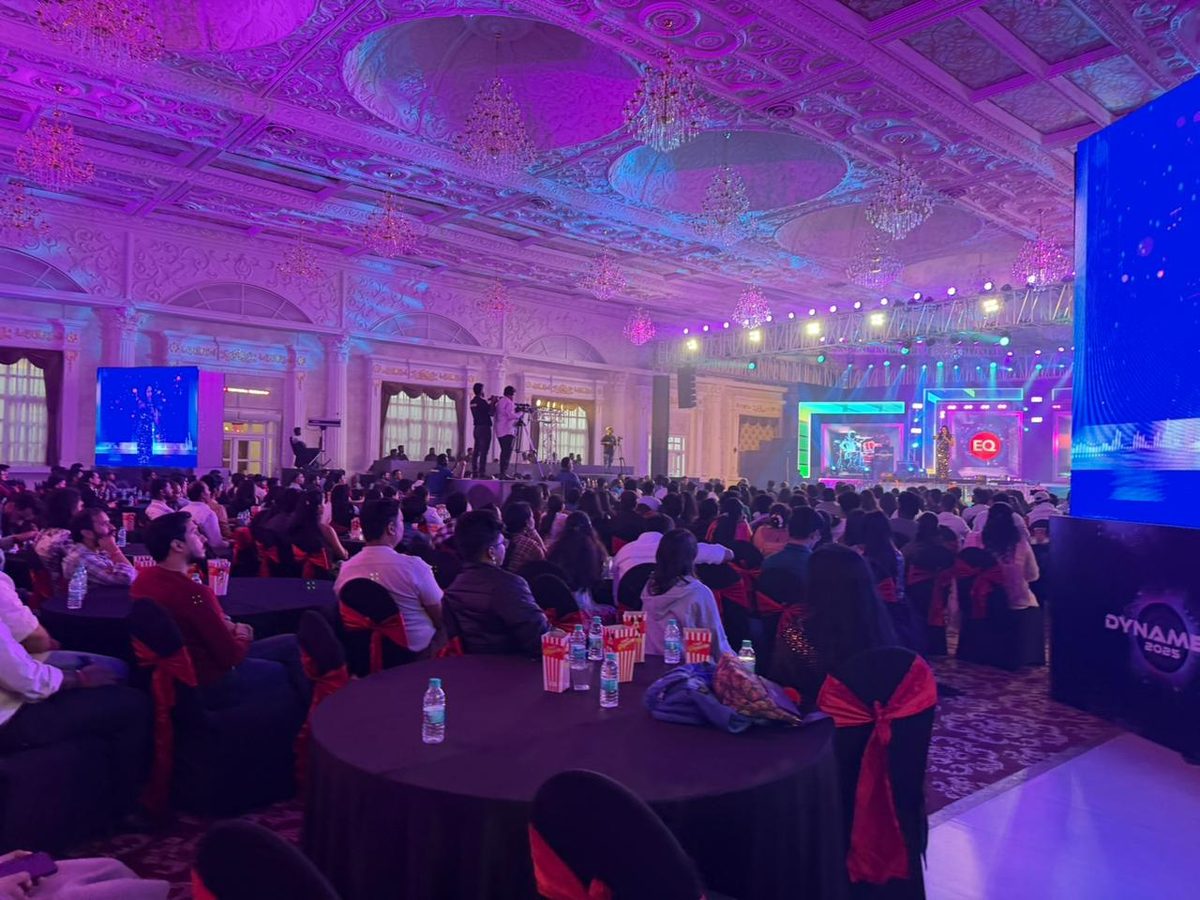 The same room, transformed. Full house, full production, zero visible chaos.