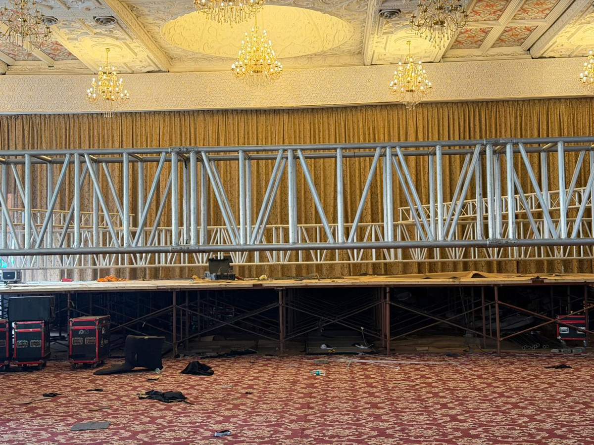 Truss up, deck down. Every cable and clamp gets checked before a single light switches on.