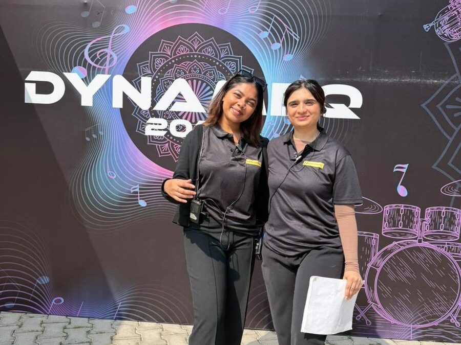 Two team I students on crew, walkie and run sheet in hand, at their first big live event