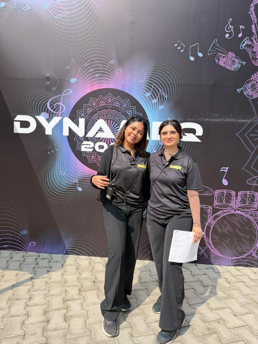 Two team I students on crew, walkie and run sheet in hand, at their first big live event
